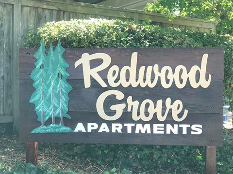 a sign that reads redwood grove apartments