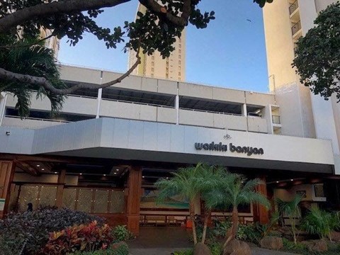 the outside of a building with palm trees