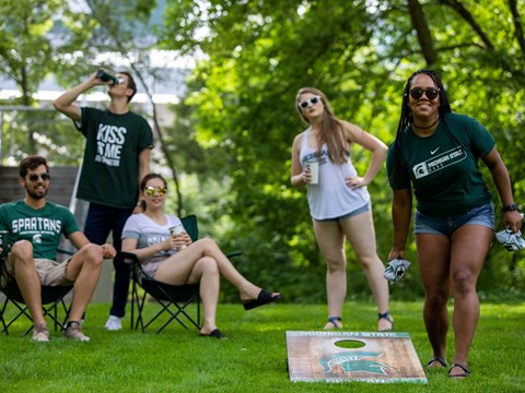 a group of people playing frisbee in a park
