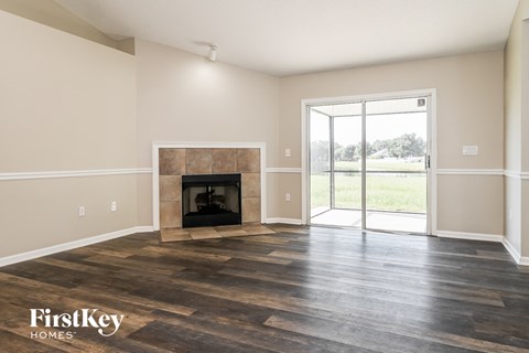 a living room with a fireplace and a sliding glass door