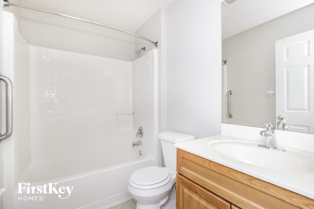 a bathroom with a sink toilet and a tub
