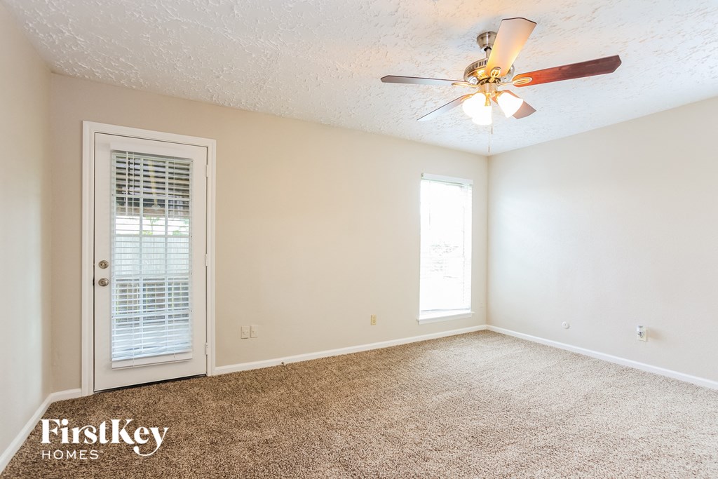 a bedroom with a ceiling fan and a door to a closet