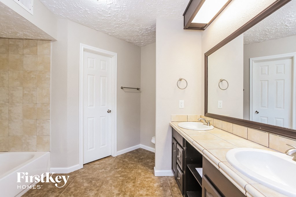 a bathroom with two sinks and a large mirror