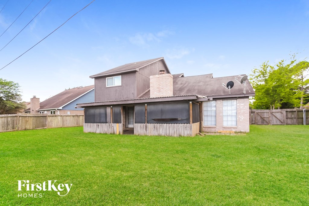 an old house with a yard and a fence