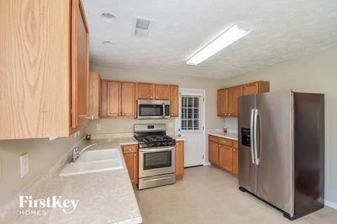 A kitchen with wooden cabinets and stainless steel appliances.