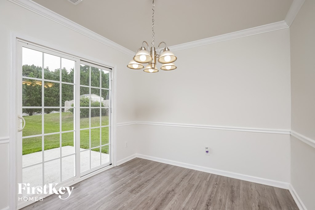 A room with a sliding glass door leading to a backyard.