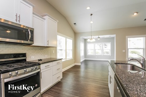 A kitchen with a FirstKey Homes stove top oven.