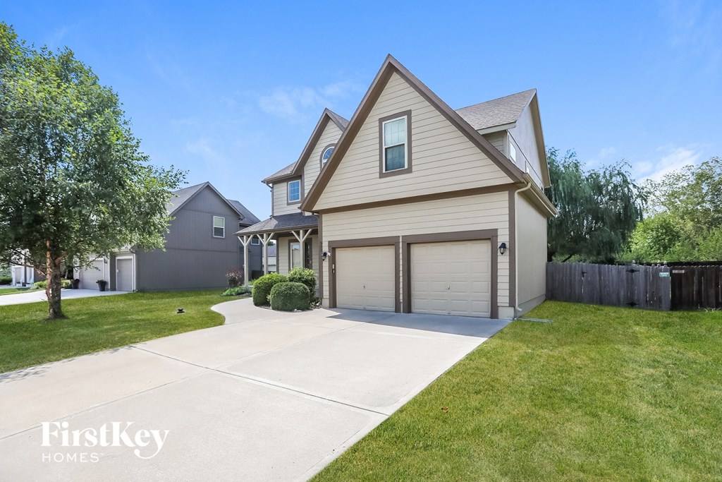 a house with a driveway and a garage door