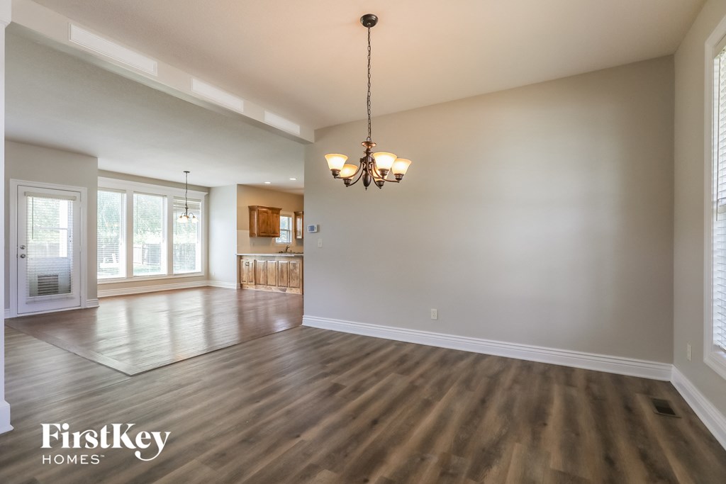 the living room and dining room of an empty house