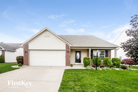 A house with a garage door and a front door with a window above it.