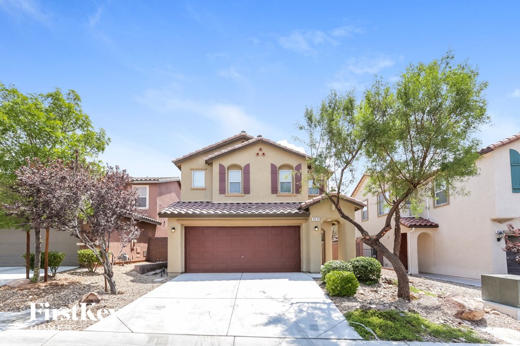 a home with a garage door in front of it