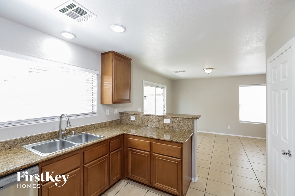 a kitchen with wooden cabinets and a sink and a counter top