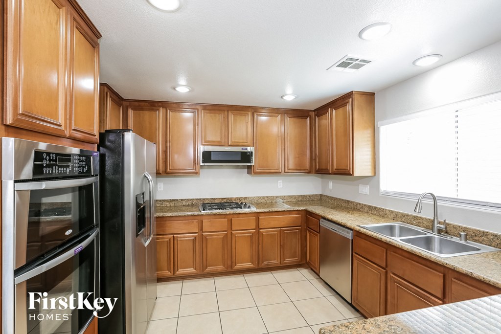 a kitchen with wooden cabinets and stainless steel appliances