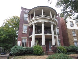 a large brick house with a large circular porch