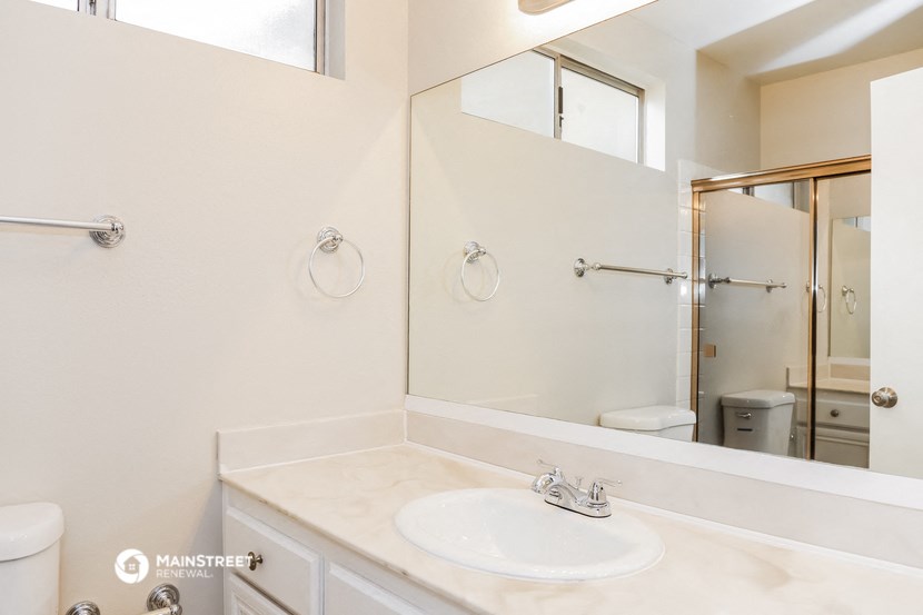a bathroom with a sink and a mirror and a shower