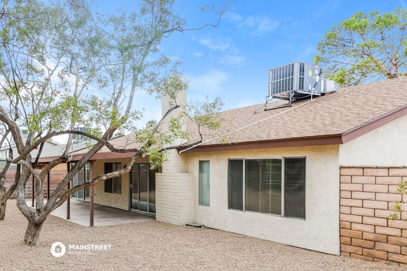 a white house with an air conditioning unit on the roof