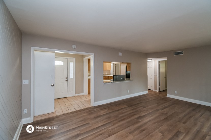 the living room and dining room of an apartment