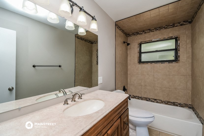 a bathroom with a sink and a toilet and a tub