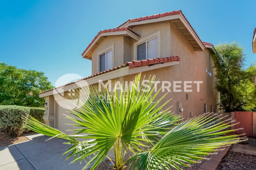 a house with a palm tree in front of it