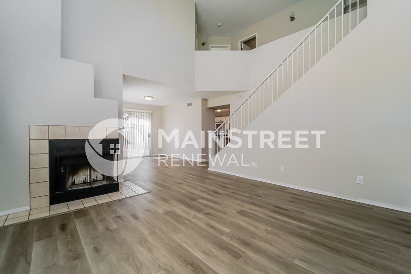 renovated living room with staircase to the second floor