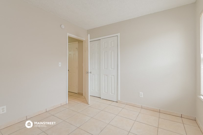 the spacious living room with a door to the hallway