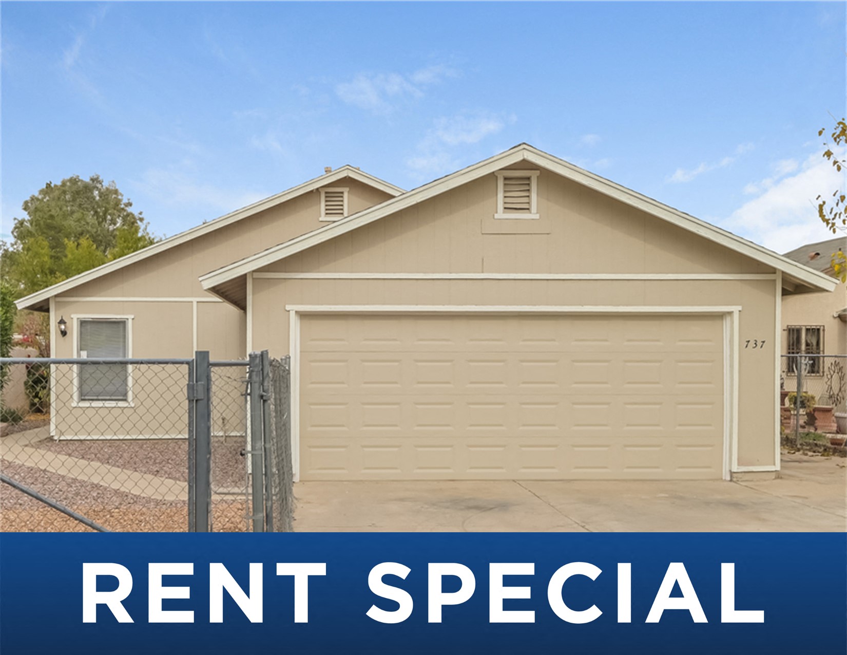 a tan house with a fence and a rent special sign