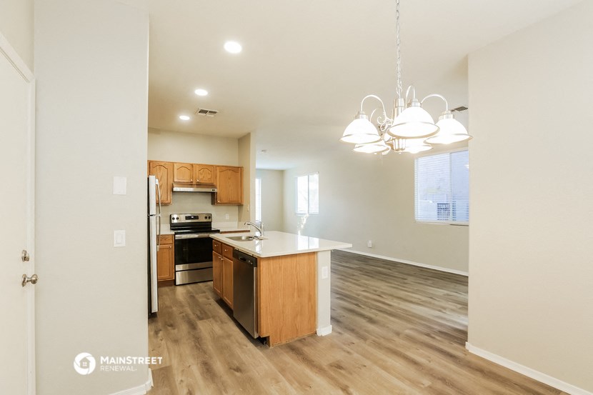 an empty kitchen and living room with a counter top