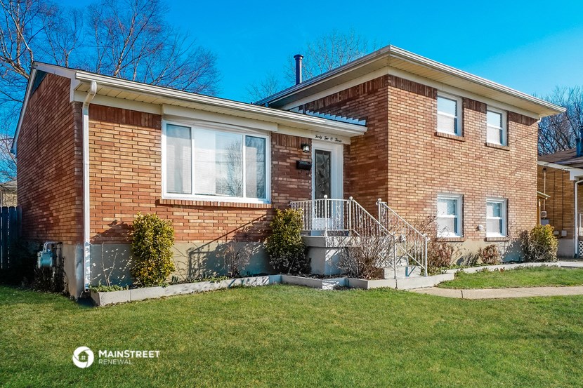 a brick house with a lawn in front of it