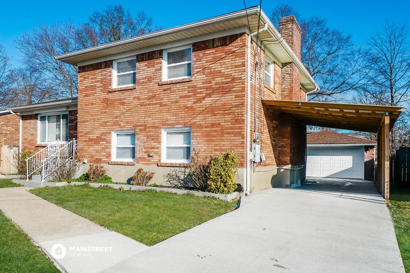 a brick house with a driveway and a garage door