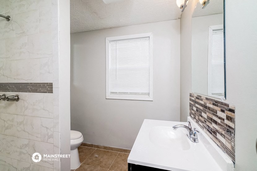 a bathroom with a sink and a toilet and a shower