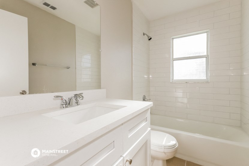 a bathroom with a sink and a toilet and a tub