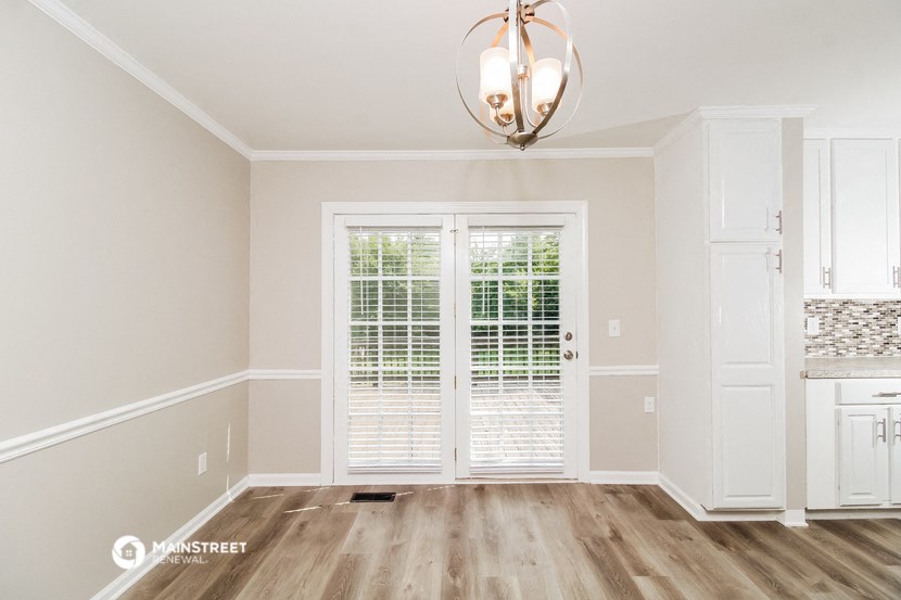 the living room of a new home with white walls and white doors