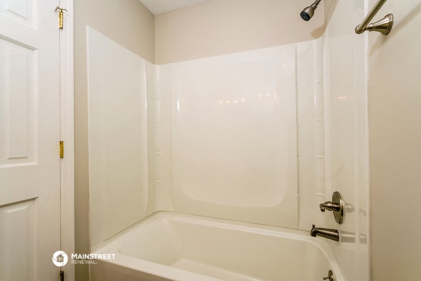 a small bathroom with a shower and a bath tub