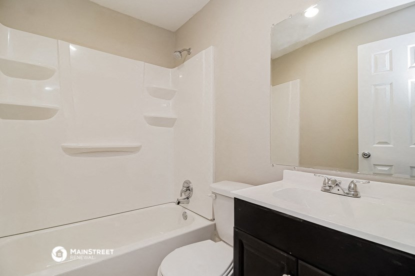 a bathroom with a sink toilet and a bath tub