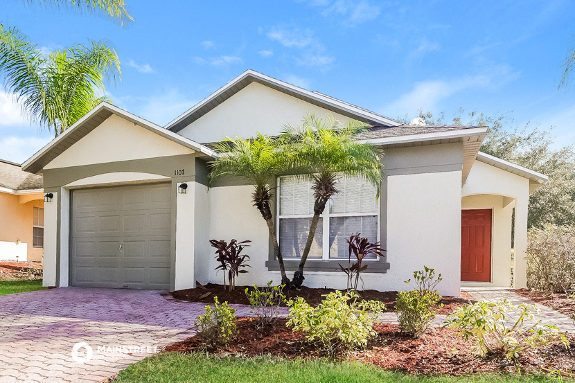 a house with palm trees in front of it