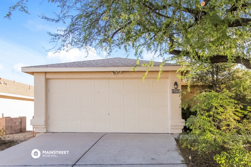 a white garage door in front of a house