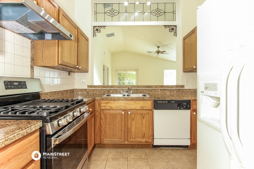 a kitchen with a stove top oven and a sink