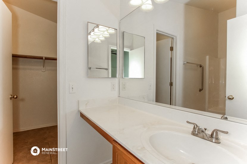 a bathroom with a sink and a mirror and a shower