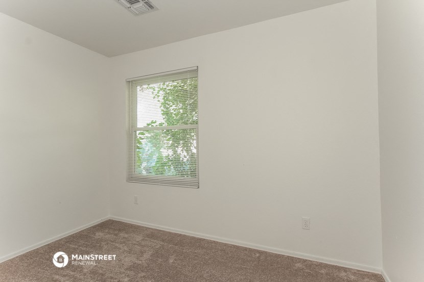 the living room of an empty house with a window