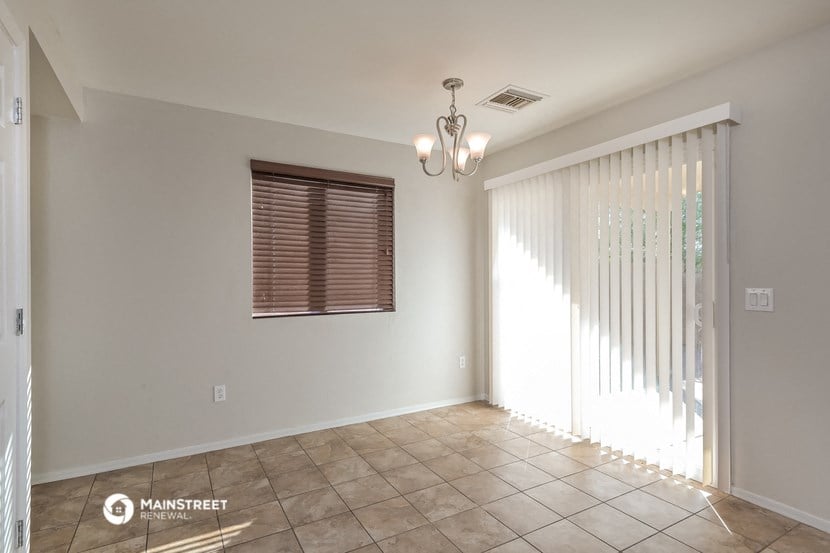 an empty living room with a sliding glass door to a patio