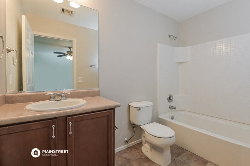 a bathroom with a sink toilet and a bath tub