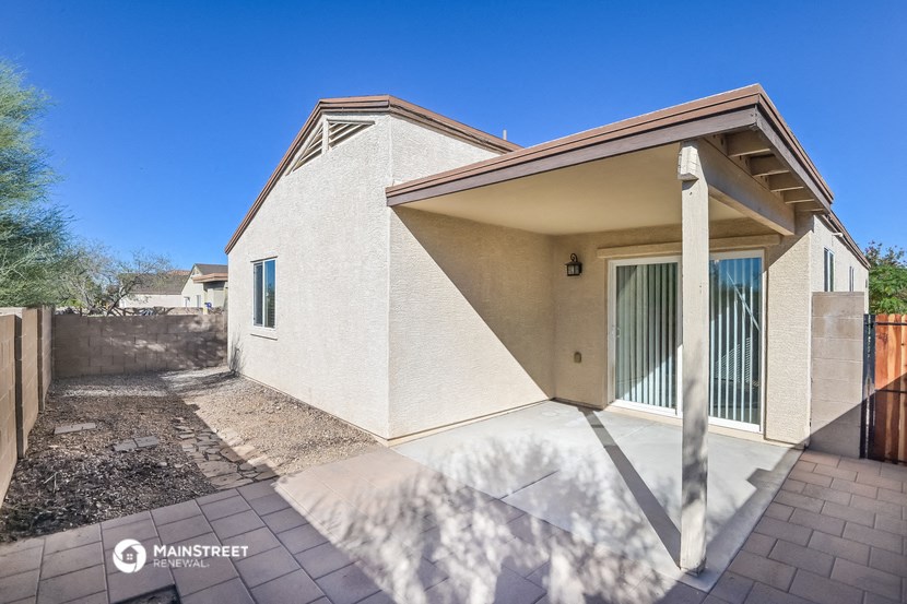 a white house with a patio and a driveway