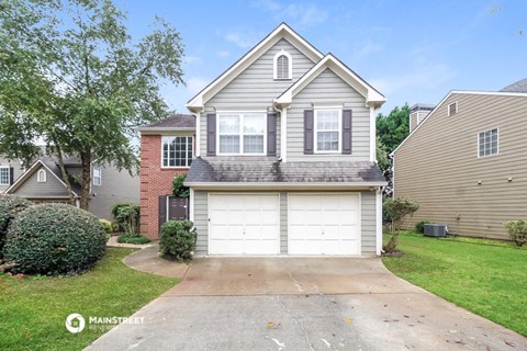 a white garage door in front of a house