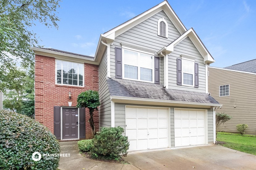a house with a garage door in front of it