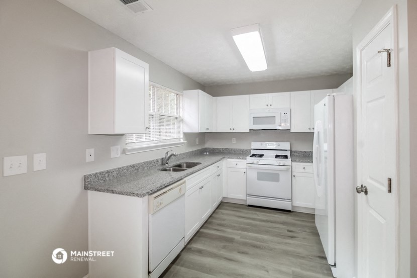 the preserve at ballantyne commons apartment kitchen with white cabinets and white appliances