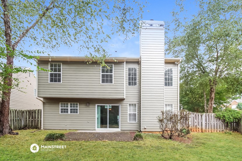 a white house with a yard and a white fence