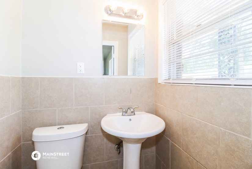 a bathroom with a sink and a mirror and a toilet