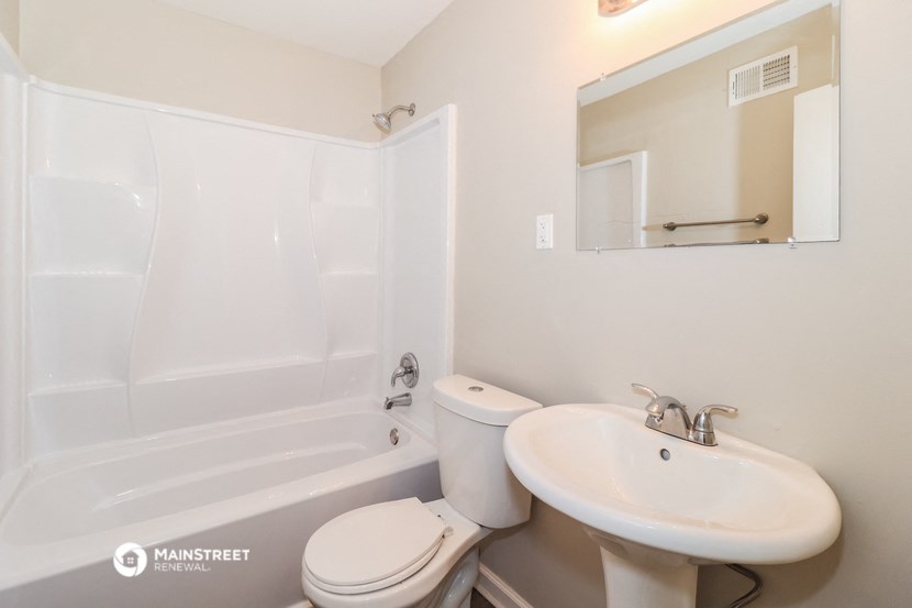 a bathroom with a sink and a toilet and a tub