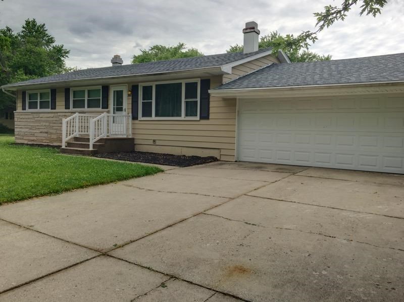 A house with a garage and a covered porch.
