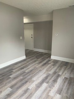 A room with a grey carpet and a white door.